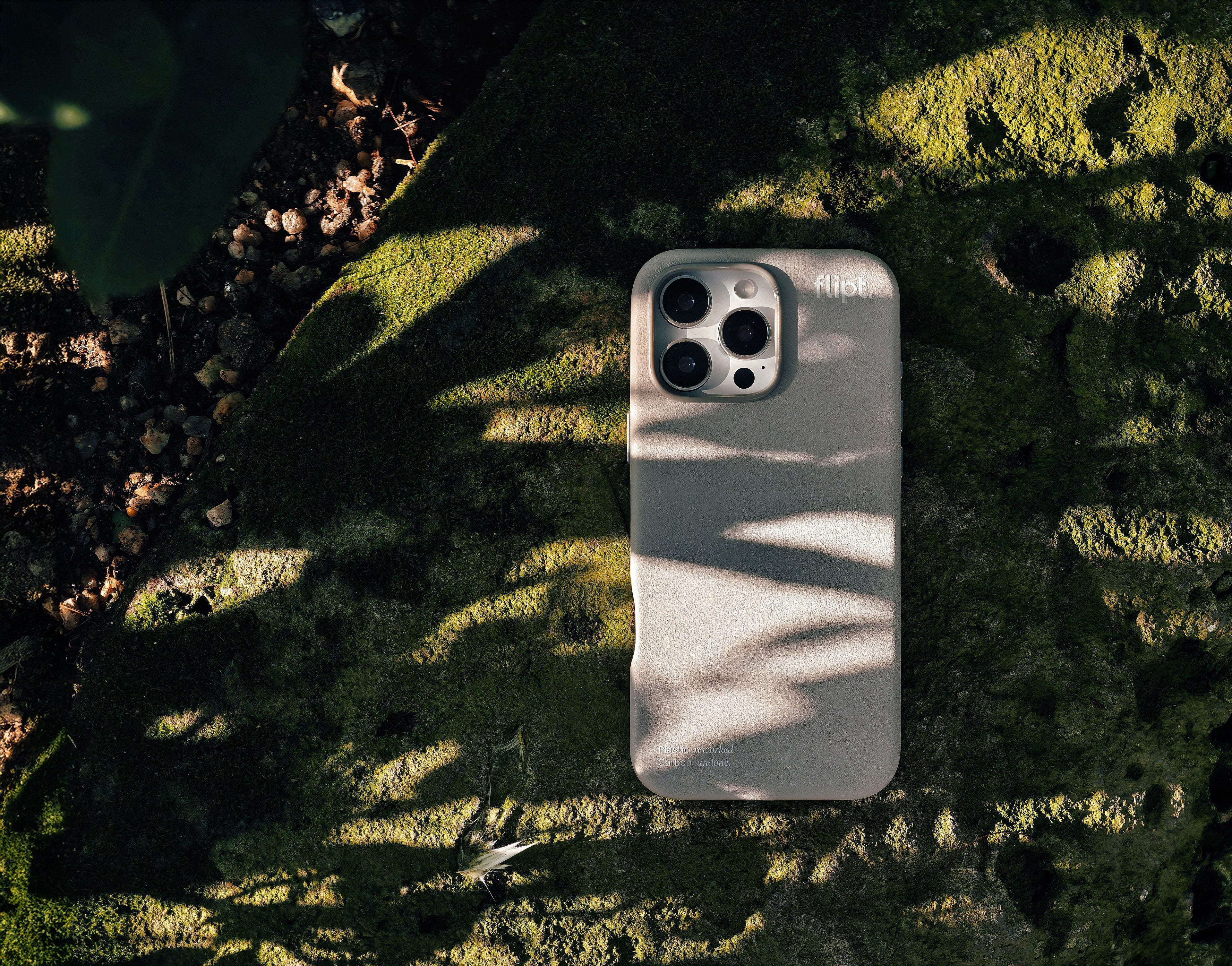 Phone case on a textured green surface